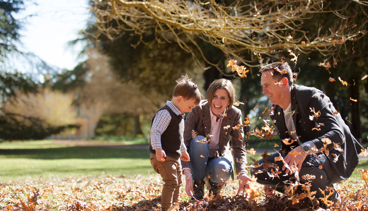 Family playing in the leaves